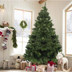 a christmas tree with presents in front of it