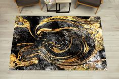 a black and gold area rug with an abstract design on the floor next to two chairs