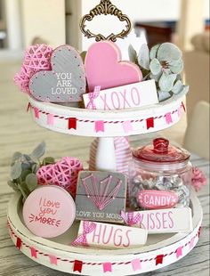 a three tiered tray with valentine's day decorations