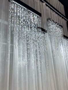 the curtains are hanging in front of the window with water droplets falling from them on it