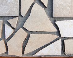 several pieces of white marble sitting on top of a wooden table