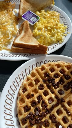 two plates with waffles and eggs on them