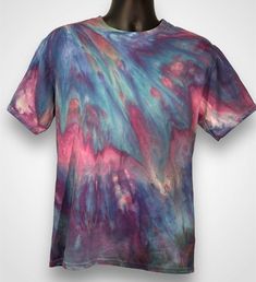 a t - shirt with an abstract design on the front and back, all in purple