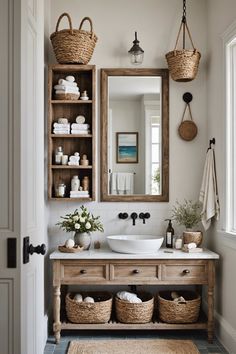 a bathroom with a sink, mirror and baskets on the wall