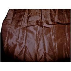 an image of a bed with brown sheets