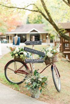 a bicycle with flowers and signs attached to it