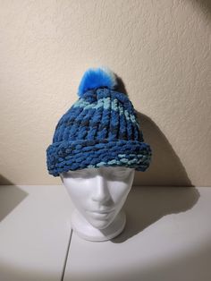 One size fits most, Kids and adults alike. This item is a handknit beanie cap. The hat contains varying shades of blues, with a poof on top that has varying shades of blue as well. The hat is extra soft and feels great to the touch. Will definitely keep your head warm. Made with super bulky #6 yarn. The dimensions are as follows: Diameter: 10 inches Circumference: 21 inches Blue Beanie, Fleece Hat, Beanie Cap, Super Bulky, Winter Hat, Feeling Great, Gift For Him, Shades Of Blue, Hand Knitting