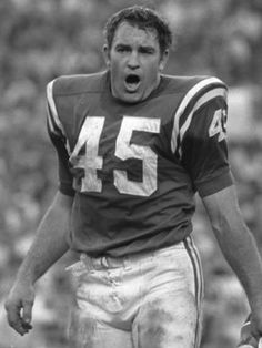 an old black and white photo of a football player