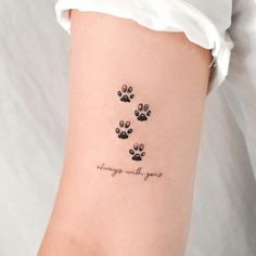 a woman with a tattoo on her arm that says always wait for the dogs to come