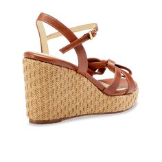 A breezy and comfortable summer style: the Mirjana Wedge 80 in saddle vachetta leather & raffia, topped with a playful interwoven bow. Chic Brown Straw Sandals, Brown Leather Wedge Sandals With Woven Sole, Brown Wedge Heel Sandals With Woven Sole, Brown Synthetic Heels With Woven Leather, Brown Woven Leather Heels, Brown Synthetic Woven Leather Heels, Leather Wedge Sandals With Woven Detail, Brown Open Toe Wedge Sandals With Woven Leather, Brown Woven Leather Wedge Sandals