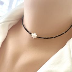 "This Magen David Choker Necklace is not just a piece of jewelry; it's a meaningful expression of faith and culture. It can be worn with pride and serves as a beautiful reminder of one's heritage. The combination of Mother of Pearl, Black Spinel, and Gold Filled elements makes this necklace a versatile and cherished accessory, suitable for both everyday wear and special occasions. It's a thoughtful and symbolic gift, celebrating both style and spirituality. NB: You can also wear this necklace as a double strands bracelet. MATERIALS: Black Spinel MOP Mother of Pearl Gold filled Measures 14\"inches 35.5cm All Loulia Pearl Jewelry orders are carefully packaged in a jewelry box with foam insert and secured with a ribbon for safe delivery. You will also get a beautiful jewelry pouch to store yo Spinel Necklace, Adjustable Black Necklace With Star Charm, Blavk Star Daphire Necklaces, Handmade Black Star Necklace, Black Star Charm Choker Necklace, Black Star Of David Necklace, Spiritual Style, Jewish Jewelry, Strand Bracelet, Black Spinel