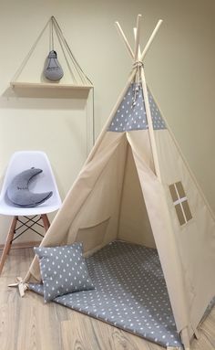 a teepee tent sitting on top of a wooden floor