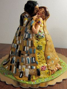 a ceramic figurine of two people hugging each other