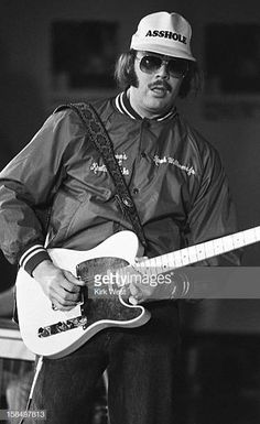 black and white photograph of man playing guitar