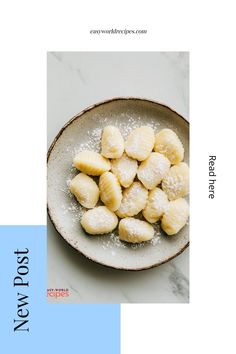 a white plate topped with bananas covered in powdered sugar on top of a marble counter