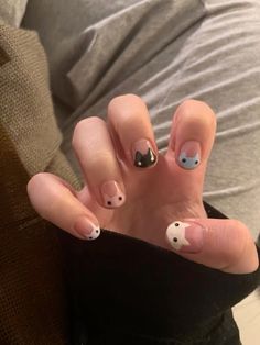 a person with black and white nail designs on their hands