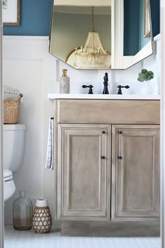 a bathroom with a sink, mirror and toilet