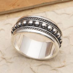 The Balinese region displays its dapper style in Komang Wijayana's sterling silver spinner ring. Crafted by local artisans, the piece features a gallant dot pattern going around the spinning central band, complemented with traditional accents in a combination of oxidized and polished finishes. Dapper Style, Silver Spinner Rings, Spinner Ring, Spinner Rings, Sterling Silver Mens, Local Artisans, Balinese, Silver Earrings Dangle, Dots Pattern