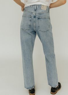 ALL SALE ITEMS ARE FINAL. The AGOLDE 90's Jean in Snapshot. Crafted with Organic Cotton, this mid-rise jean offers a relaxed fit through the hips and a loose, straight leg for effortless style. With a clean, vintage indigo wash and a subtle distressed hem, this timeless piece will only get softer with each wash. Relaxed fit. Size down for a closer fit. Available in Snapshot 100% Organic Cotton Machine wash cold inside out with like colors. Do not bleach. Tumble dry low. Button Fly Closure Rise: 90s Jean, Designer Jeans For Women, 90s Jeans, Vintage Indigo, Jeans Online, Designer Jeans, Mid Rise Jeans, Clothing Boutique, Timeless Pieces