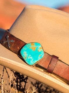 This band is what started it all! Our Pinnacle band on vintage latigo leather is such a statement piece! I couldn't see all the latigos on our ranch getting thrown out and visualized a large geometric piece of turquoise as a buckle, and made it happen. Theses chunks of Kingman turquoise are outstanding and I find the ranchiest leather possible! You will love it! We can add any western charms to the bands, Arrows, Conchos, or Bucking horses. Adjustable Turquoise Western Belt Buckles, Southwestern Leather Belt Buckles For Rodeo, Vintage Adjustable Turquoise Belt, Adjustable Vintage Turquoise Belt, Adjustable Turquoise Vintage Belt, Western Turquoise Belt With Concho, Turquoise Western Belt With Concho, Southwestern Leather Belt Buckles For Western-themed Events, Rustic Hand Tooled Adjustable Belt Buckles