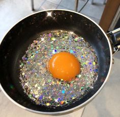 an egg in a frying pan with glitters