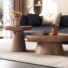 a living room filled with furniture and a vase on top of a table in front of a window