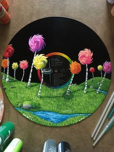 an image of some lollipops in the grass on a round plate with markers