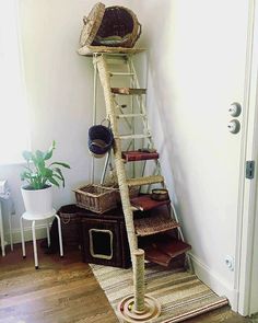 there is a ladder that has baskets on top of it and a basket in the bottom