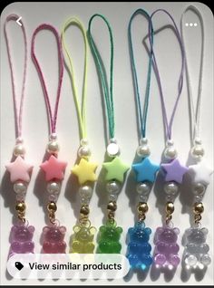 six different colored teddy bear charms with bells