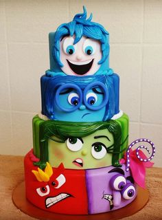 a three tiered cake with monsters on it