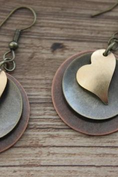 Finish : Antiqued Copper coin drop ( 25 mm or 1 inch ) , Antique brass disc and antique brass Heart. Length: 2 inches including the antique brass hooks ear wires The antique copper and brass discs have been domed by myself. Please check out my Valentine gift for her section for more choices : https://www.etsy.com/shop/NtikArtJewelry?ref=seller-platform-mcnav§ion_id=36789575 Thanks for looking !!! Mother's Day Heart Drop Earrings, Metal Heart Pendant Earrings For Anniversary, Mother's Day Heart Pendant Earrings For Pierced Ears, Valentine's Day Metal Drop Earrings, Mother's Day Heart Pendant Earrings, Double Heart Metal Earrings For Gift, Metal Dangle Earrings For Valentine's Day, Heart Charm Drop Earrings For Mother's Day, Metal Earrings With Ear Wire For Valentine's Day