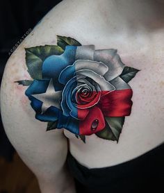 a woman's chest with a rose and ribbon tattoo design on the left side