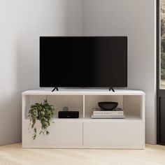 a flat screen tv sitting on top of a white entertainment center