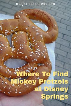 there is a bagel with sesame seeds on it and the words where to find mickey pretzels at disney springs