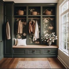 a room with green cabinets and flowers on the wall