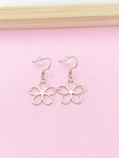 Rose Gold Japanese Cherry Blossom Charm Earrings, Peace Charm, Peace Plum Flower Charm, Girlfriend Gift,  HOW TO ORDER 1) Select the quantity 2) Select style  3) Add to cart DESCRIPTION ♥ Rose Gold over stainless steel ear hook 19-22mm. or 14.5x12 mm hoop ♥ Alloy Pendants, Lead & Nickel Safe, Approx: 22x21x1mm ** Conversion: 1 inch = 25.4mm or 1mm = 0.0393 inches** ♥ Handmade to order, please allow 3-5 days for us to make your item before shipping, ♥ Jewelry comes on Lebua Jewelry card, wrapped in a plastic covering, then placed in a gift bag. *Items will be bag separate.* ♥ All personalization is done by HAND. ♥ Raw materials the USA and international sourcing. ♥ I do not include invoices in any packages unless requested. ♥ *Return & Exchange, the item must be in original condition! * I a Earrings Peace, Stethoscope Necklaces, Bag Items, Medical Student Gift, Plum Flowers, Japanese Cherry Blossom, Jewelry Card, Childrens Jewelry, Girlfriend Gift