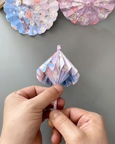 someone is making an origami flower out of paper