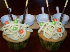 two cupcakes with noodles and carrots on them