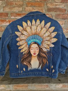 a denim jacket with an image of a woman wearing a headdress