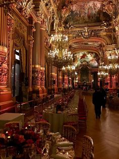 an elaborately decorated dining hall with chandeliers and tables set for formal function