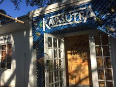 a store front with the name kauauna painted on it's glass doors