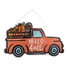 an orange truck with a basket full of pumpkins on the back that says hello fall