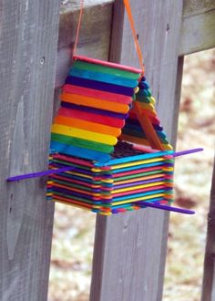 a bird house made out of colored sticks