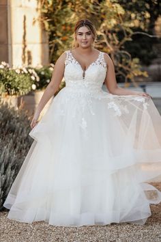 a woman in a wedding dress posing for the camera