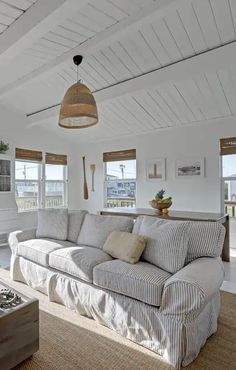 a living room filled with furniture and lots of windows