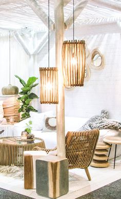 a living room filled with lots of furniture and decor on top of a white floor