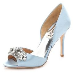 a woman's blue high heeled shoe with a flower on the toe and an embellishment