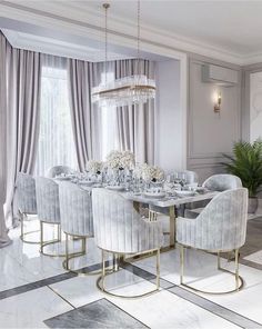 an elegant dining room with marble flooring and white walls, large chandelier