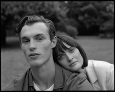 a man and woman are posing for a black and white photo