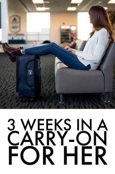 a woman sitting on a couch with her feet up in the air and luggage behind her